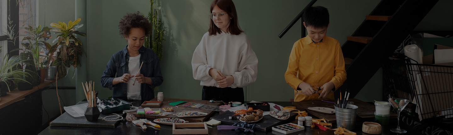 Young creatives collaborating on craft projects in a creative workshop
