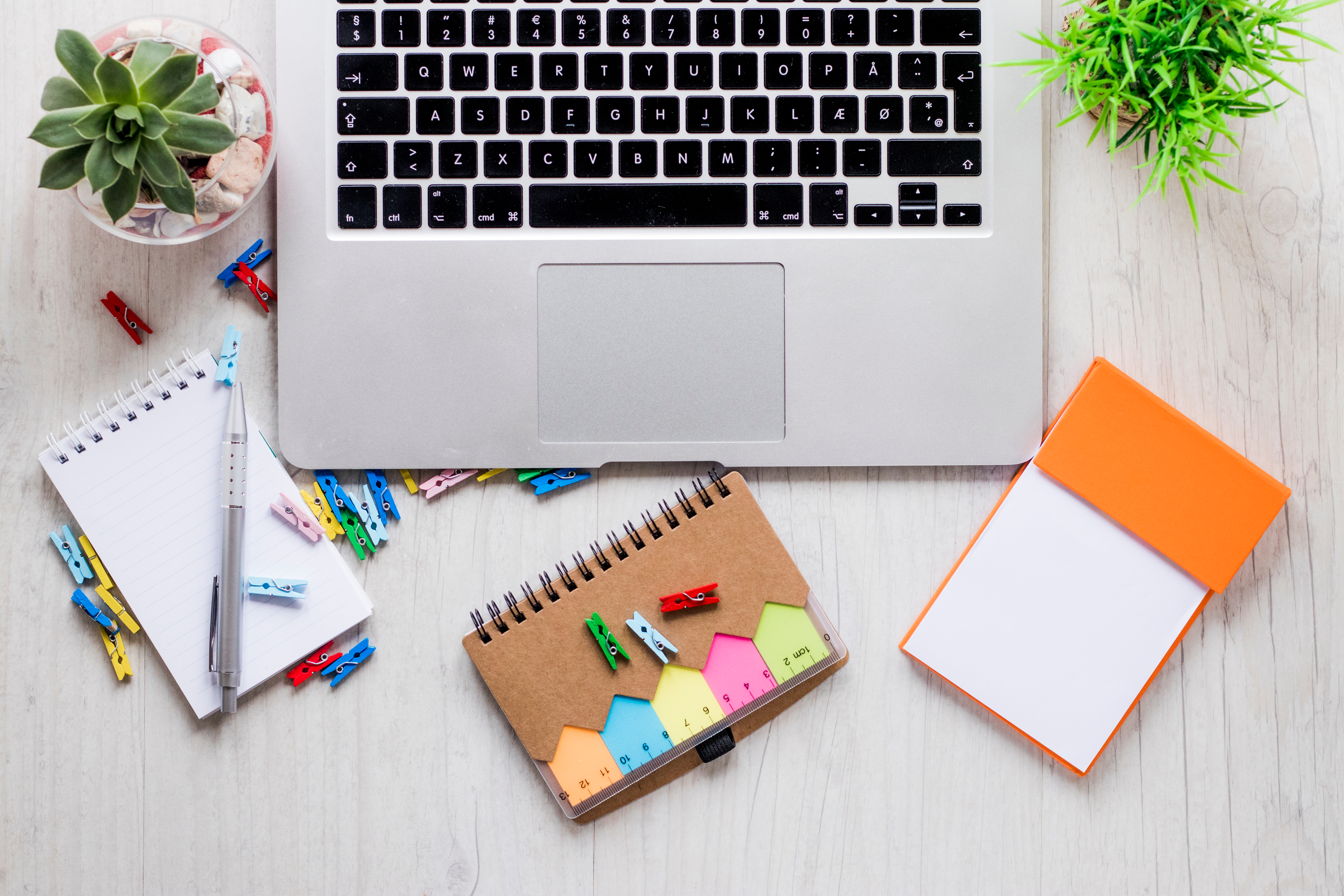 Design workspace with laptop and creative supplies